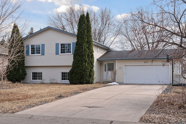 split level home featuring an attached garage and concrete driveway