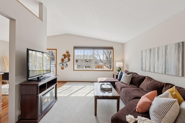 living area featuring carpet flooring and vaulted ceiling