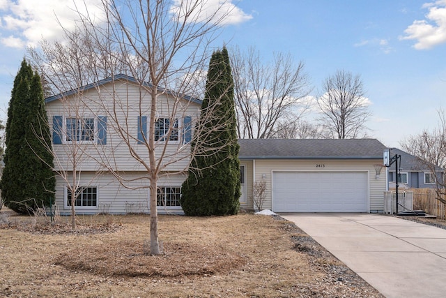 view of front of property featuring an attached garage, fence, and driveway