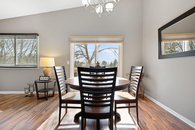 dining room with wood finished floors, baseboards, and a chandelier