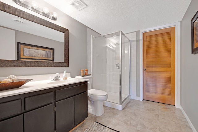 bathroom featuring vanity, visible vents, a stall shower, a textured ceiling, and toilet