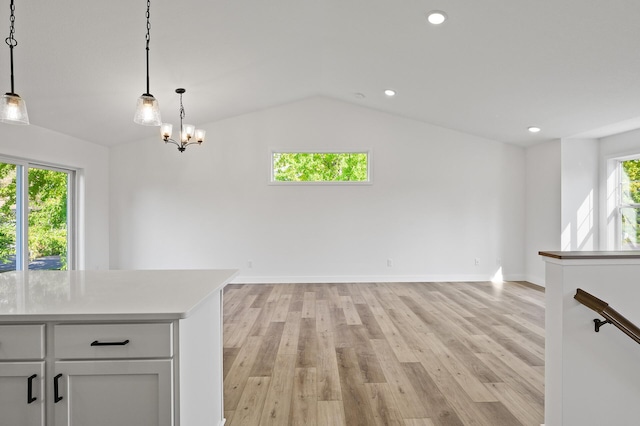 interior space featuring recessed lighting, baseboards, light wood-style flooring, and vaulted ceiling