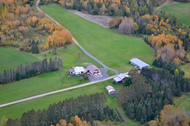 aerial view featuring a rural view and a wooded view