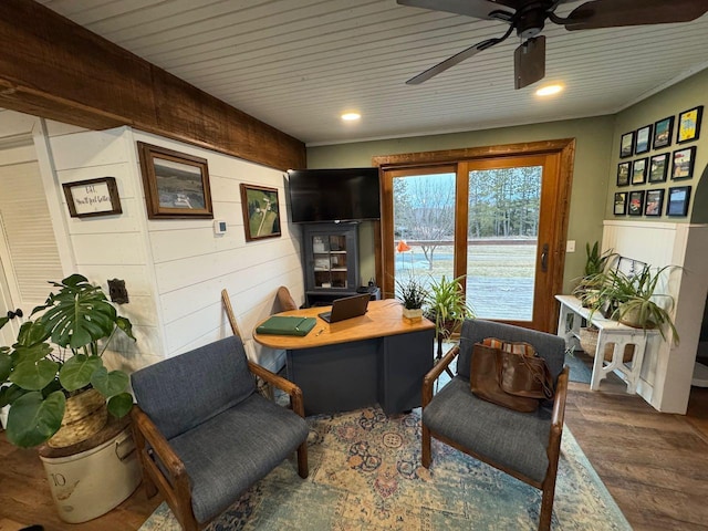 office area with wood ceiling, wooden walls, wood finished floors, and ceiling fan