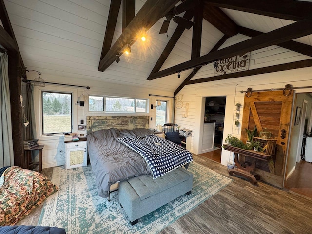 bedroom with wood finished floors, multiple windows, wood walls, and vaulted ceiling with beams