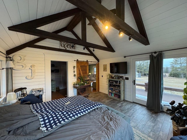 bedroom featuring wood finished floors, lofted ceiling with beams, wood walls, a barn door, and access to outside