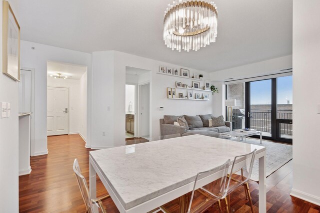 500 Grant St Unit 807, Minneapolis, MN 55404 - dining room featuring baseboards, a notable chandelier, and dark wood finished floors