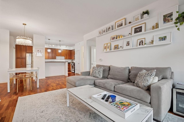 500 Grant St Unit 807, Minneapolis, MN 55404 - living room featuring baseboards, a notable chandelier, and dark wood-style flooring