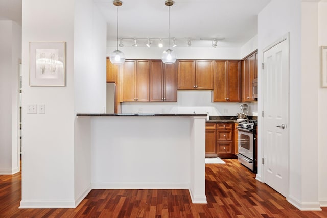 500 Grant St Unit 807, Minneapolis, MN 55404 - kitchen featuring dark countertops, dark wood finished floors, stainless steel appliances, and brown cabinets