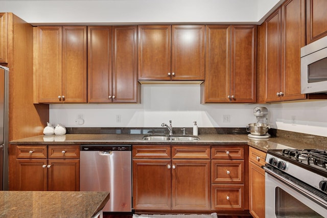 500 Grant St Unit 807, Minneapolis, MN 55404 - kitchen featuring brown cabinetry, appliances with stainless steel finishes, dark stone counters, and a sink