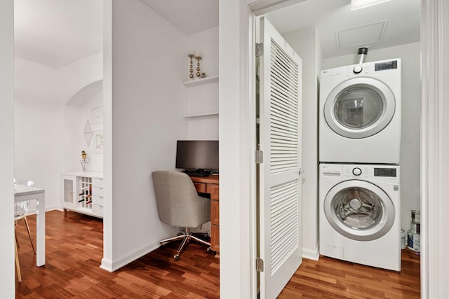 500 Grant St Unit 807, Minneapolis, MN 55404 - laundry room with laundry area, wood finished floors, stacked washer and clothes dryer, and baseboards