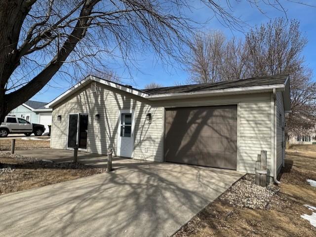 exterior space with a garage and concrete driveway