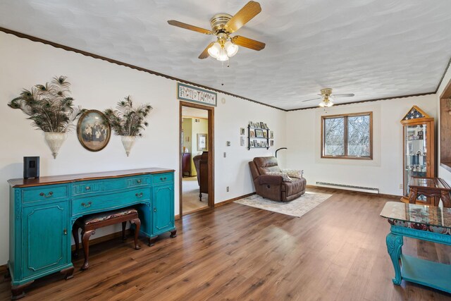 living area featuring dark wood-type flooring, baseboards, ornamental molding, a ceiling fan, and a baseboard radiator