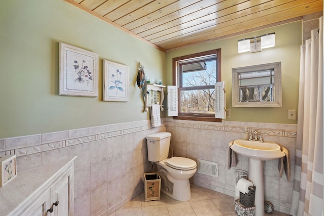 full bath featuring visible vents, a sink, tile patterned flooring, wood ceiling, and toilet