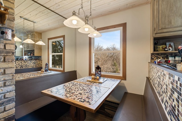 dining space with wooden ceiling and plenty of natural light