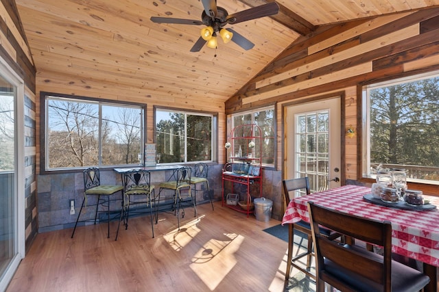 sunroom featuring wood ceiling, lofted ceiling with beams, and ceiling fan