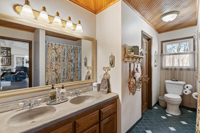 full bath with double vanity, toilet, crown molding, and a sink