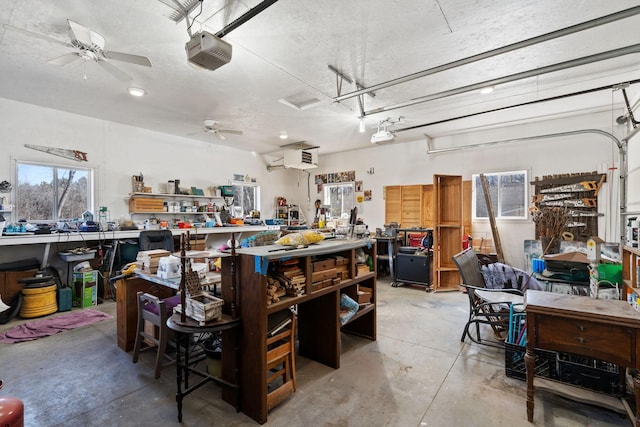 garage featuring a workshop area, a garage door opener, and ceiling fan