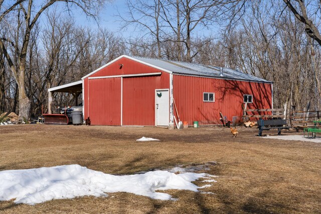 view of pole building featuring a yard and fence