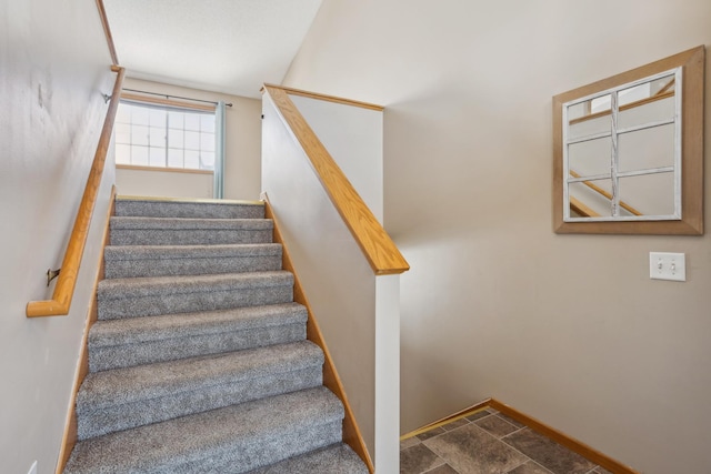 staircase featuring baseboards