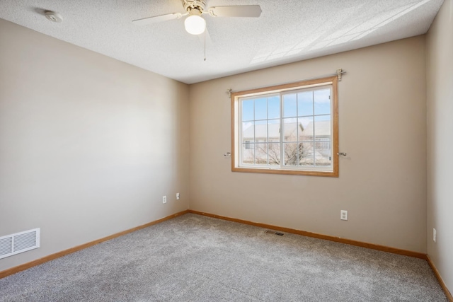 unfurnished room featuring baseboards, visible vents, carpet floors, and ceiling fan