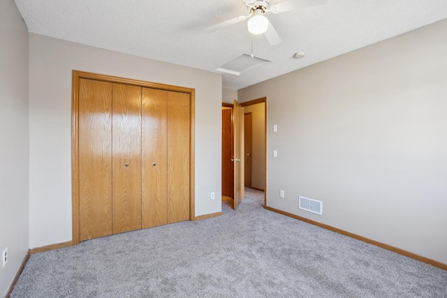 unfurnished bedroom with a closet, visible vents, carpet flooring, and baseboards