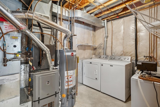 washroom with independent washer and dryer, laundry area, and water heater