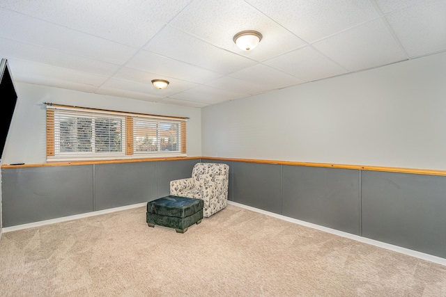 unfurnished room featuring a paneled ceiling and carpet floors