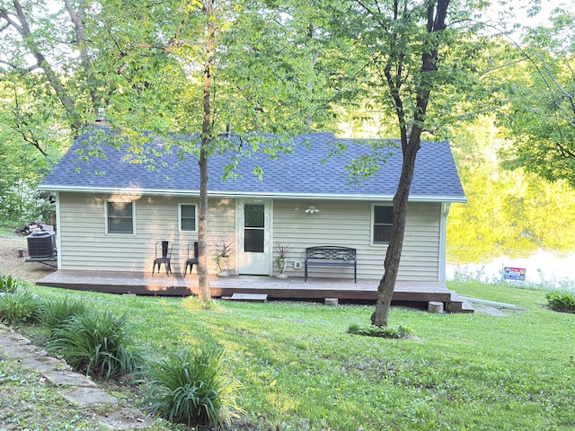 2897 Indian Mound Rd, Luck, WI 54853 - rear view of house featuring central AC unit, a yard, a deck, and a shingled roof
