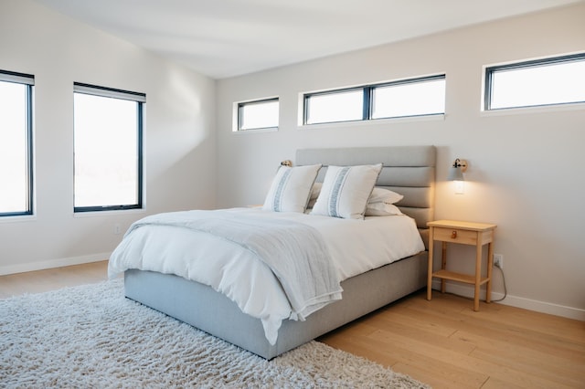 bedroom featuring baseboards and light wood-style flooring