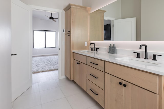 full bath with a sink, ceiling fan, double vanity, and tile patterned flooring