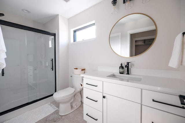 full bath featuring a stall shower, toilet, and vanity