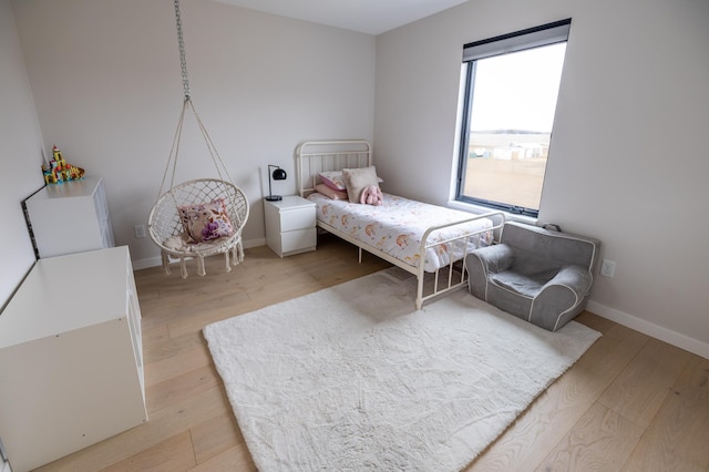 bedroom featuring light wood-type flooring and baseboards