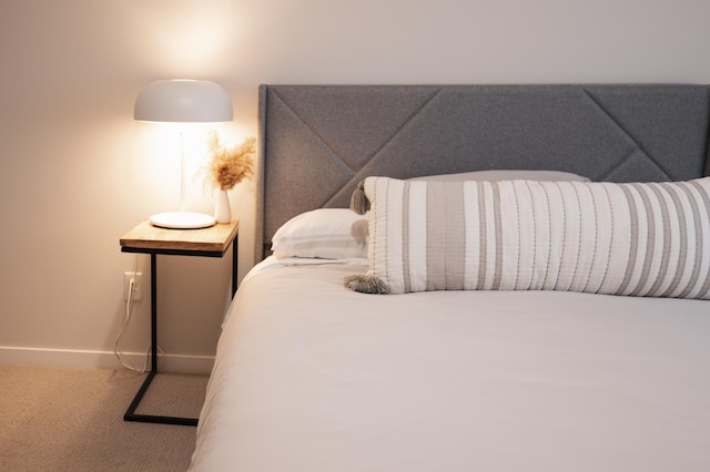 bedroom featuring baseboards and carpet floors