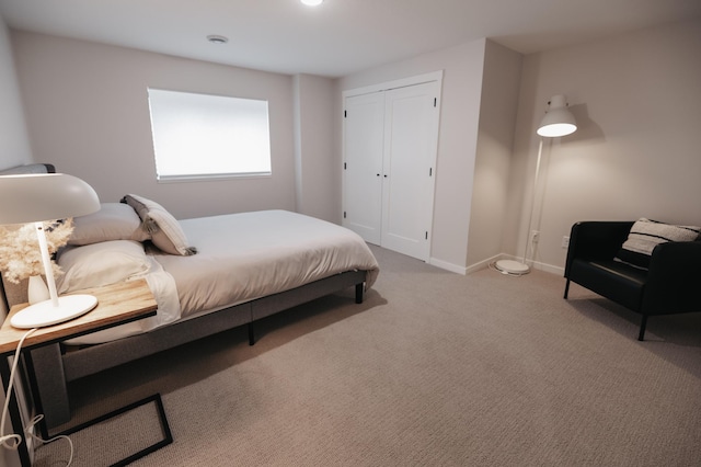 bedroom with a closet, baseboards, and carpet