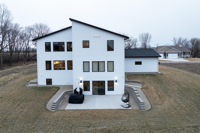 back of house with a yard and a patio