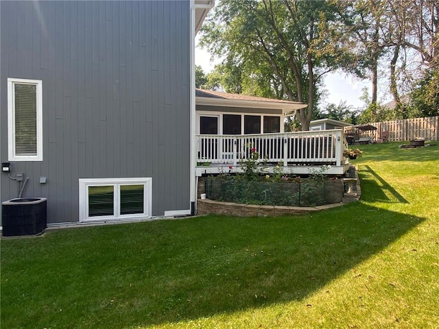 view of yard with central AC unit and a sunroom