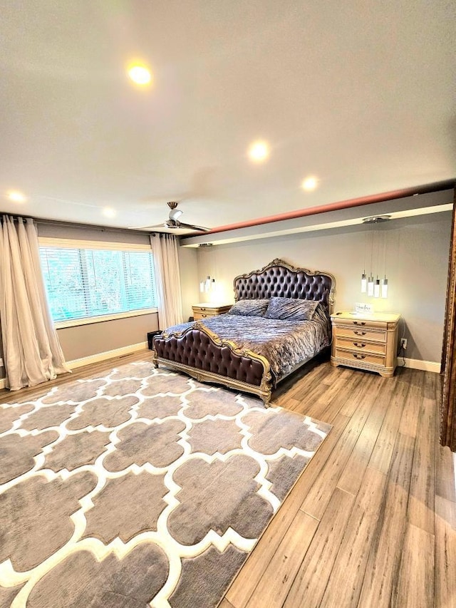 bedroom featuring baseboards and wood finished floors