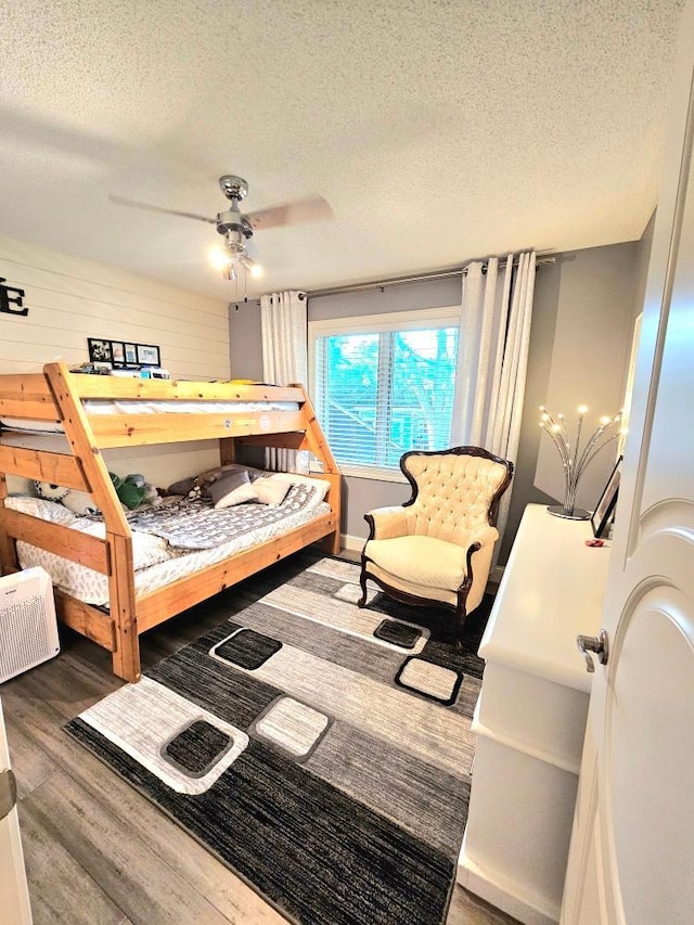 bedroom featuring a textured ceiling and wood finished floors