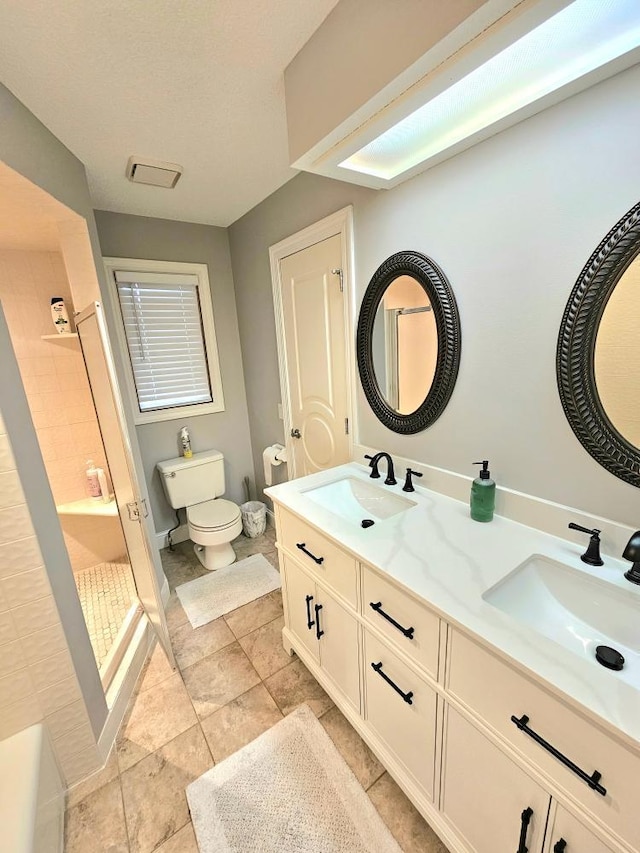 904 155th St, Burnsville, MN 55306 - full bathroom featuring a tile shower, toilet, double vanity, baseboards, and tile patterned floors