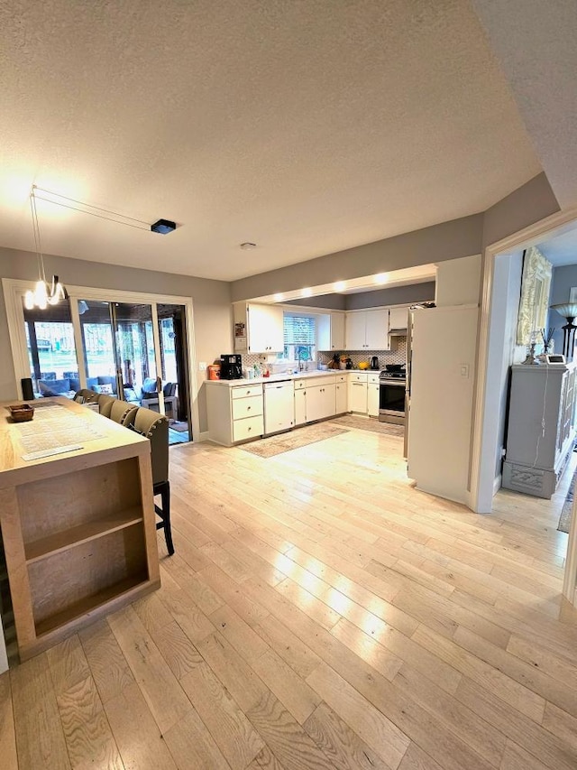 904 155th St, Burnsville, MN 55306 - kitchen featuring a textured ceiling, stainless steel range with gas cooktop, dishwasher, a chandelier, and light wood finished floors