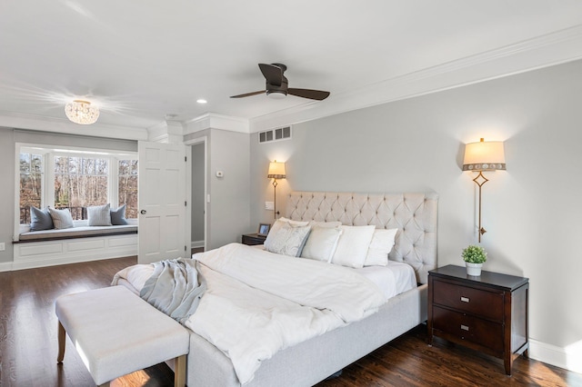 bedroom featuring visible vents, crown molding, baseboards, dark wood finished floors, and a ceiling fan