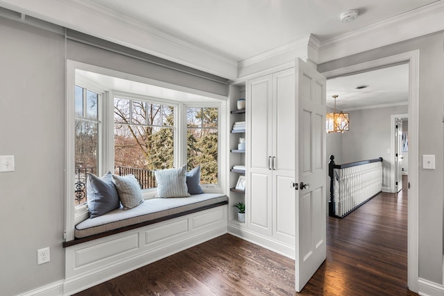 living area featuring baseboards, dark wood-type flooring, an inviting chandelier, and crown molding