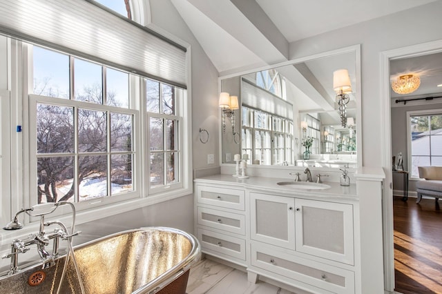 bathroom with vanity and lofted ceiling