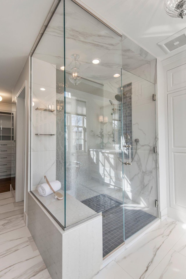 bathroom featuring marble finish floor and a marble finish shower