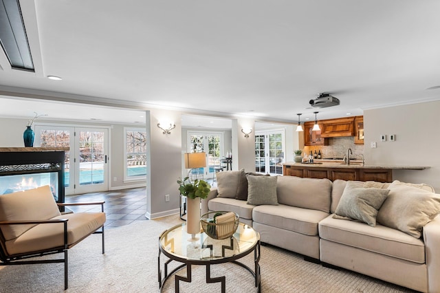 living room featuring light tile patterned flooring, recessed lighting, crown molding, and baseboards