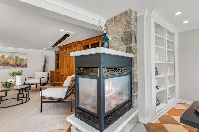 interior space with a stone fireplace, recessed lighting, baseboards, and ornamental molding