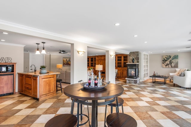 interior space featuring recessed lighting, ornamental molding, and a fireplace