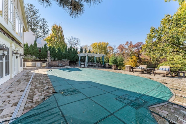 view of pool with a patio area and a pergola