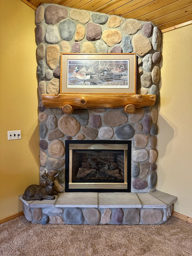 interior details with a fireplace, baseboards, and carpet floors